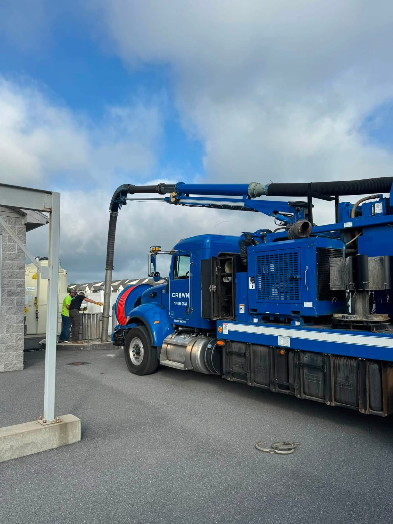 Crown Hydrovac blue vacuum truck with boom extended at a Pennsylvania job site